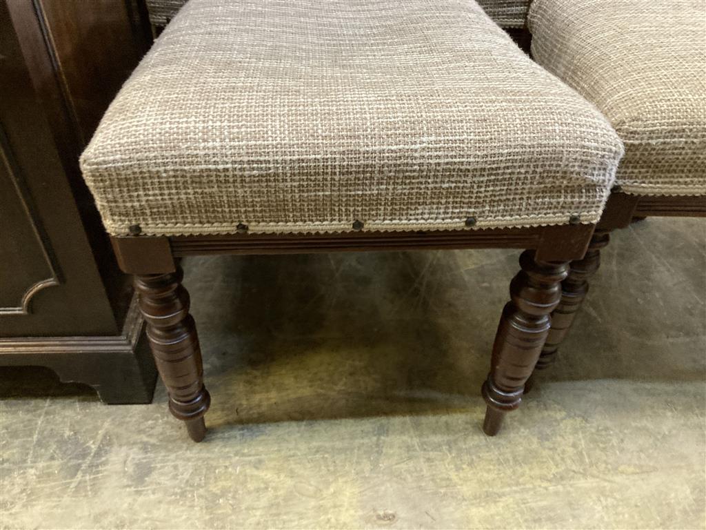 A set of four late Victorian walnut dining chairs